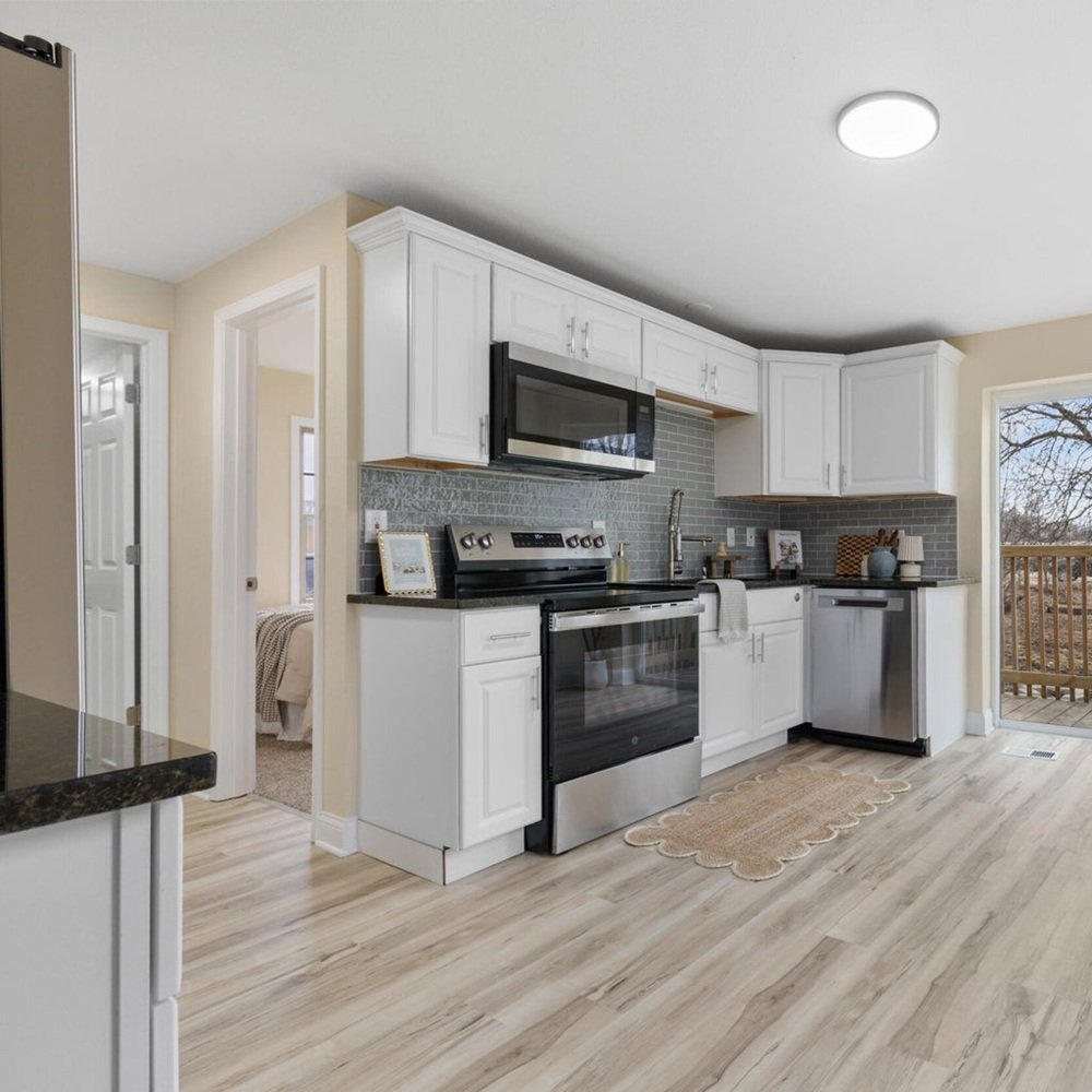 Designer adjusting furniture layout to highlight flow and scale in occupied home in wisconsin