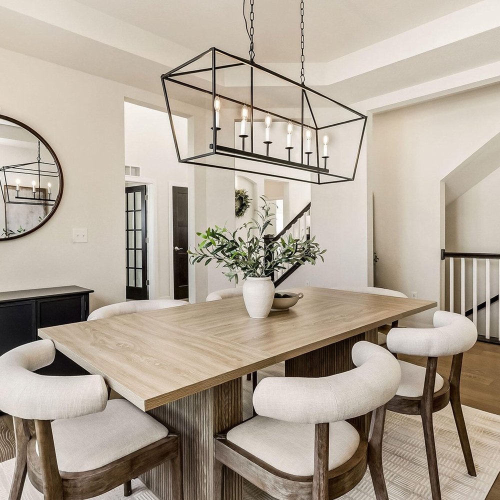 Designer reviewing furniture, finishes, and layout plans with homeowner in living room in wisconsin