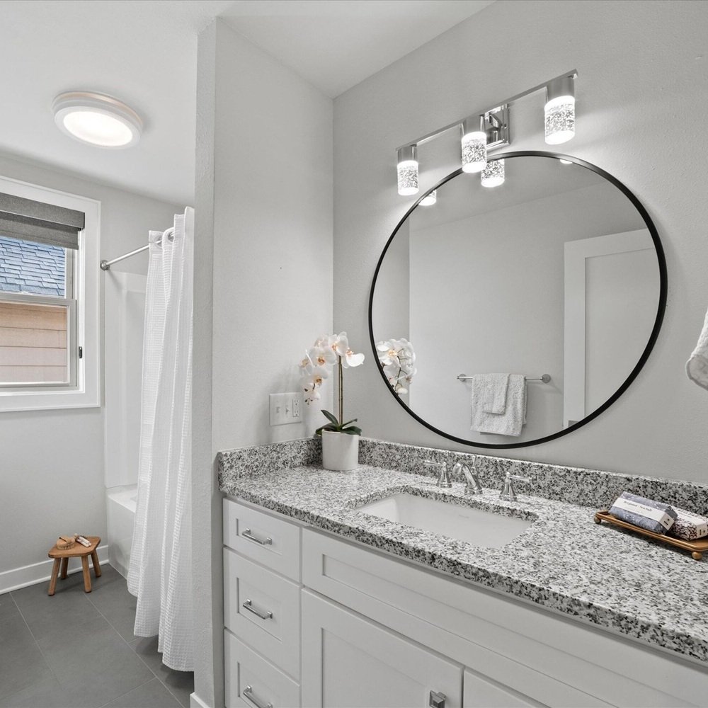 Home stager adjusting existing furniture and decor for polished buyer-ready presentation